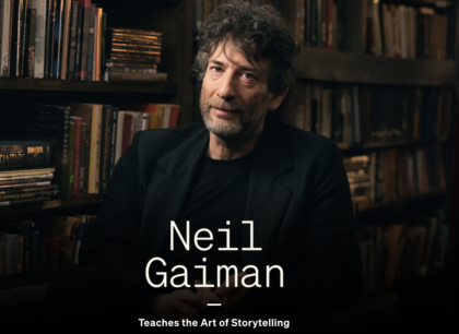 Neil Gaiman in front of a bookcase